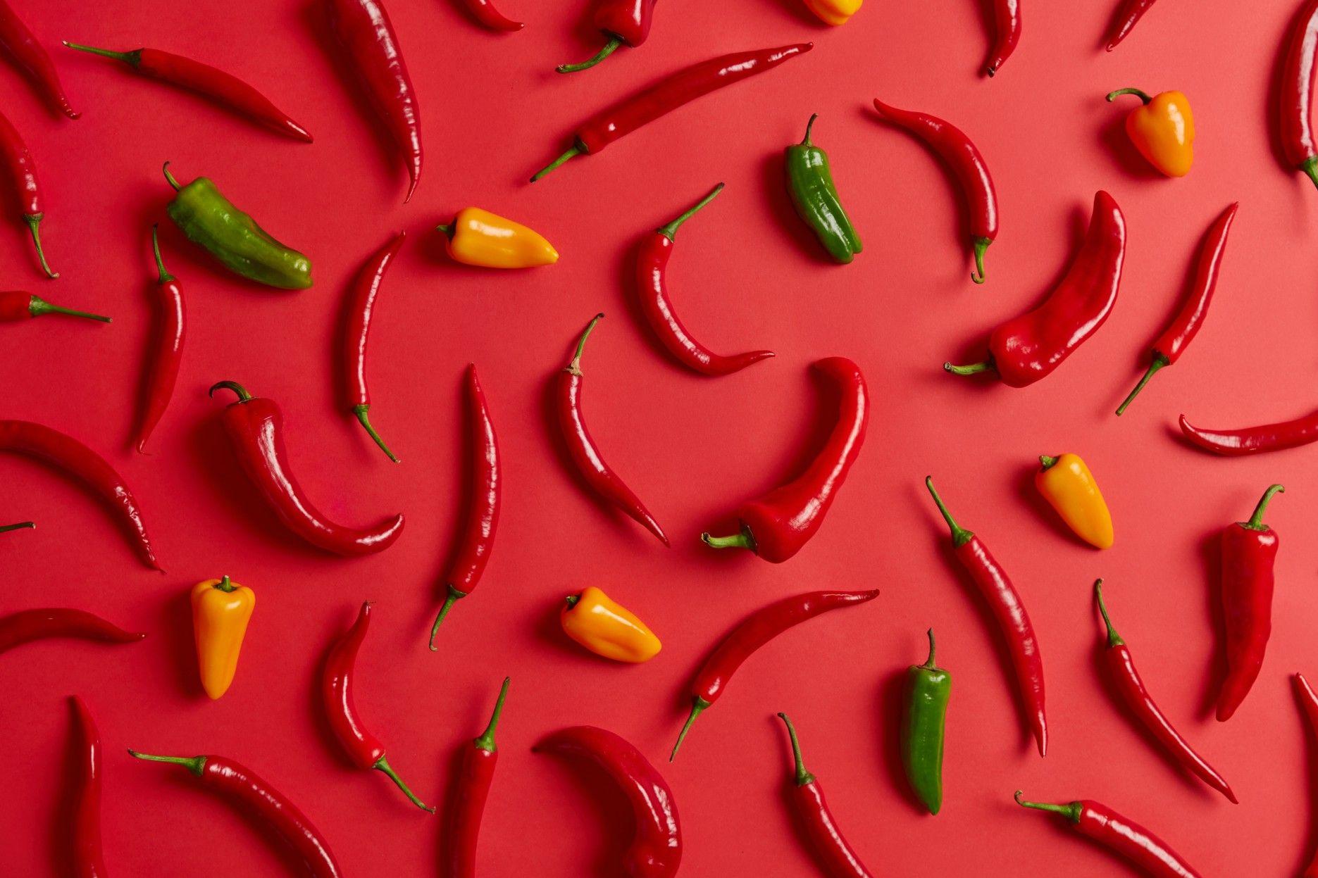 colorful-chili-peppers-red-vibrant-background-organic-food-concept-fresh-hot-vegetable-dishes-seasoning-food-concept-view-from-flat-lay-healthy-ingredient-heat-spicy-product.jpg